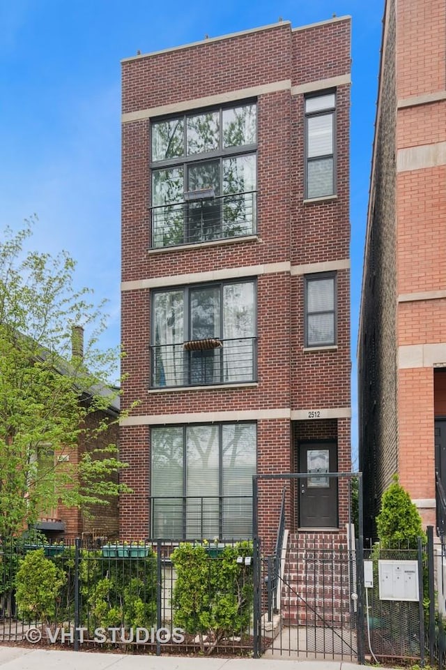 2512 W Thomas St Unit 3, Chicago, IL 60622 - view of front facade with fence private yard and brick siding