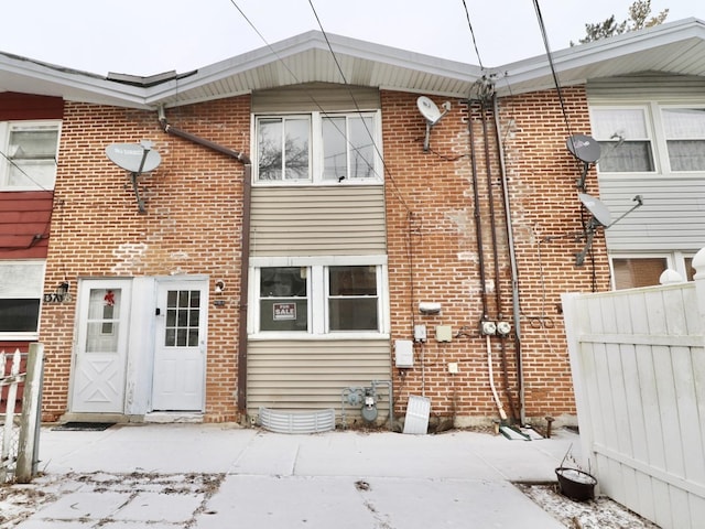 exterior space with fence and brick siding