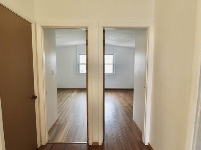 hall featuring dark wood finished floors and baseboards