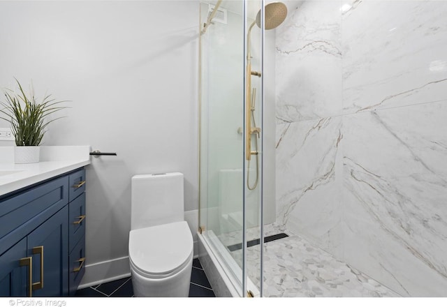 1030 N State St Unit 21K, Chicago, IL 60610 - bathroom featuring tile patterned floors, toilet, vanity, and a marble finish shower