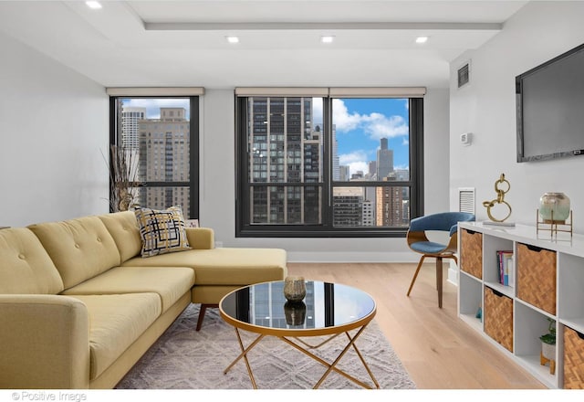 1030 N State St Unit 21K, Chicago, IL 60610 - living area featuring visible vents, a wealth of natural light, wood finished floors, and a city view