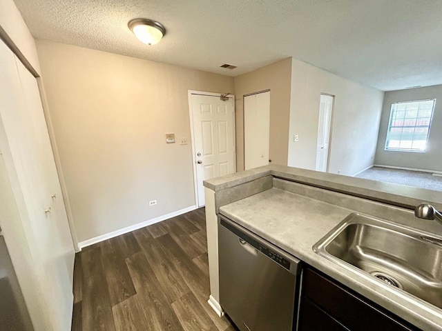 1915 N Hicks Rd Unit 105, Palatine, IL 60074 - kitchen with stainless steel dishwasher, light countertops, a sink, visible vents, and dark wood-type flooring