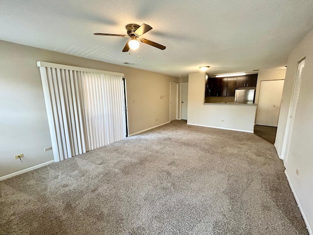 1915 N Hicks Rd Unit 105, Palatine, IL 60074 - unfurnished living room featuring baseboards, a ceiling fan, and carpet flooring