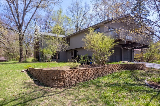 view of property exterior featuring a yard and an attached garage