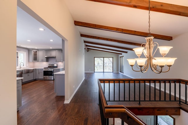 dining area with a chandelier, baseboards, dark wood finished floors, and lofted ceiling with beams