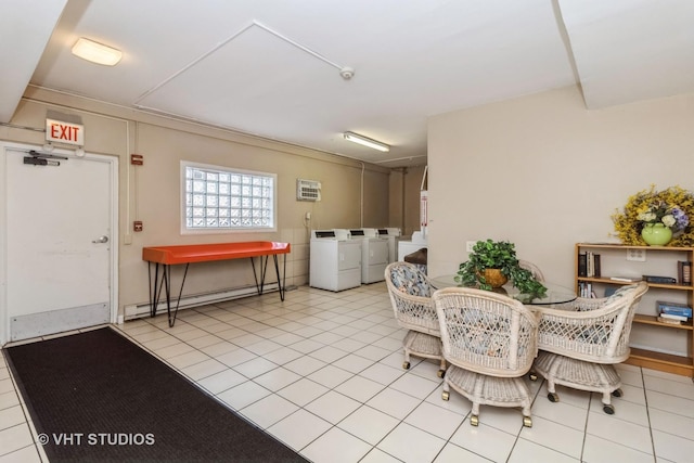 tiled dining space featuring a baseboard heating unit and washing machine and clothes dryer