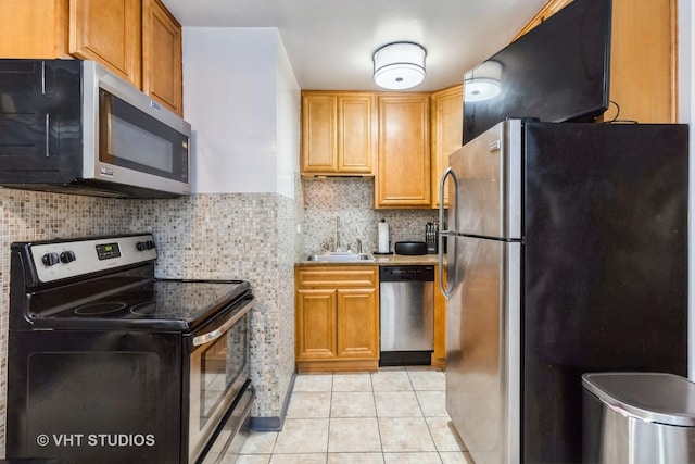 7428 Washington St Unit 304, Forest Park, IL 60130 - kitchen with light tile patterned floors, a sink, light countertops, tasteful backsplash, and appliances with stainless steel finishes