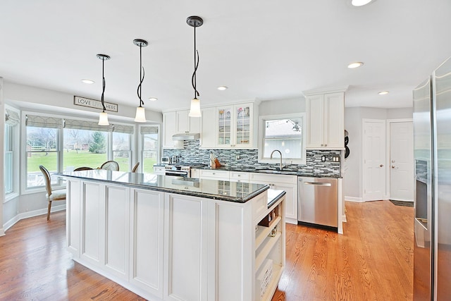 25441 N Marilyn Ln, Hawthorn Woods, IL 60047 - kitchen with light wood-style flooring, stainless steel appliances, backsplash, a sink, and white cabinetry