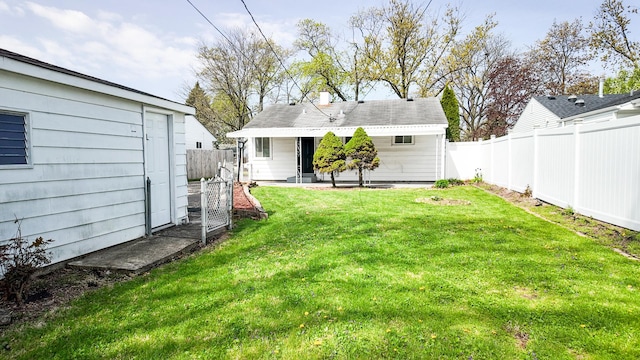 view of yard featuring a fenced backyard and an outdoor structure