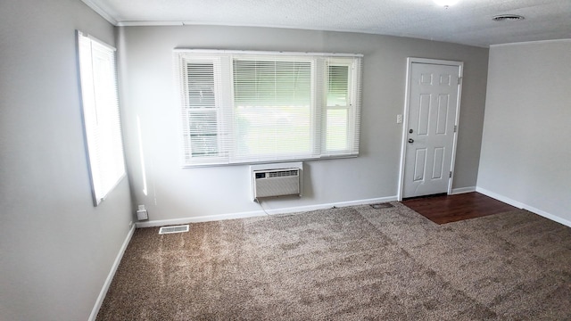 entrance foyer with carpet flooring, baseboards, visible vents, and a wall unit AC
