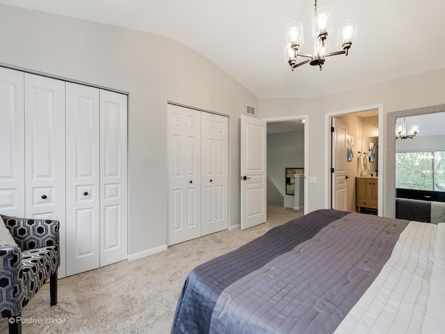 bedroom with two closets, light colored carpet, vaulted ceiling, visible vents, and a notable chandelier