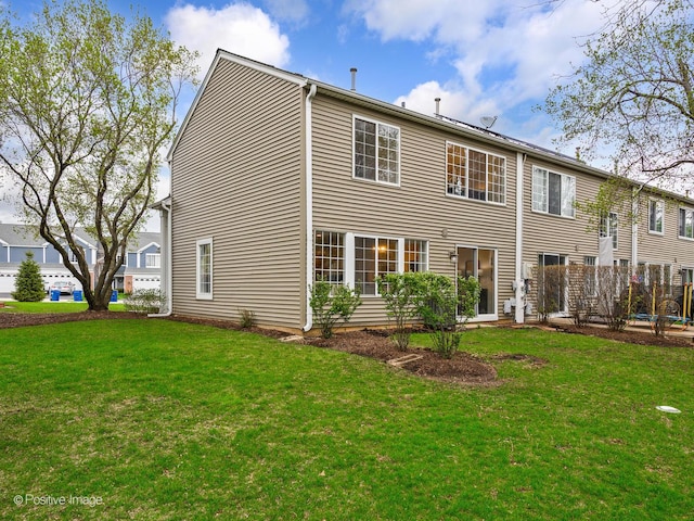 back of house with a lawn