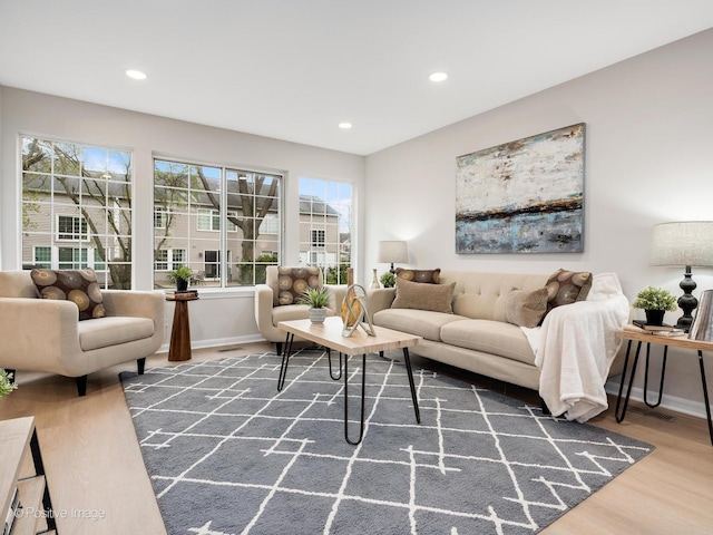 living area featuring baseboards, recessed lighting, wood finished floors, and visible vents