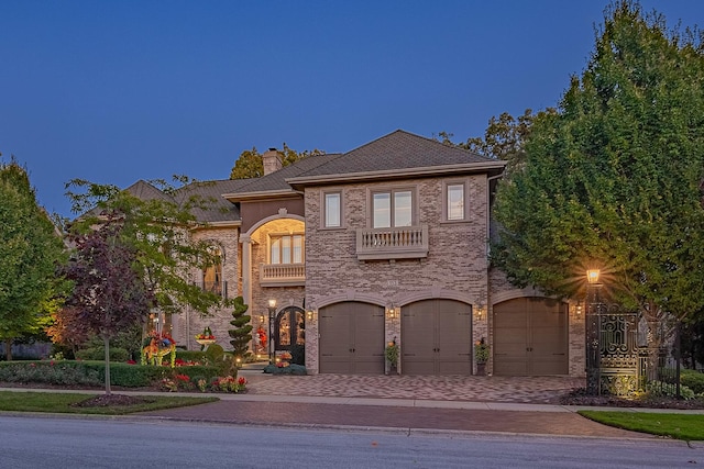 113 Carmela Ct, Bloomingdale, IL 60108 - view of front of home featuring a balcony, a garage, decorative driveway, a chimney, and brick siding