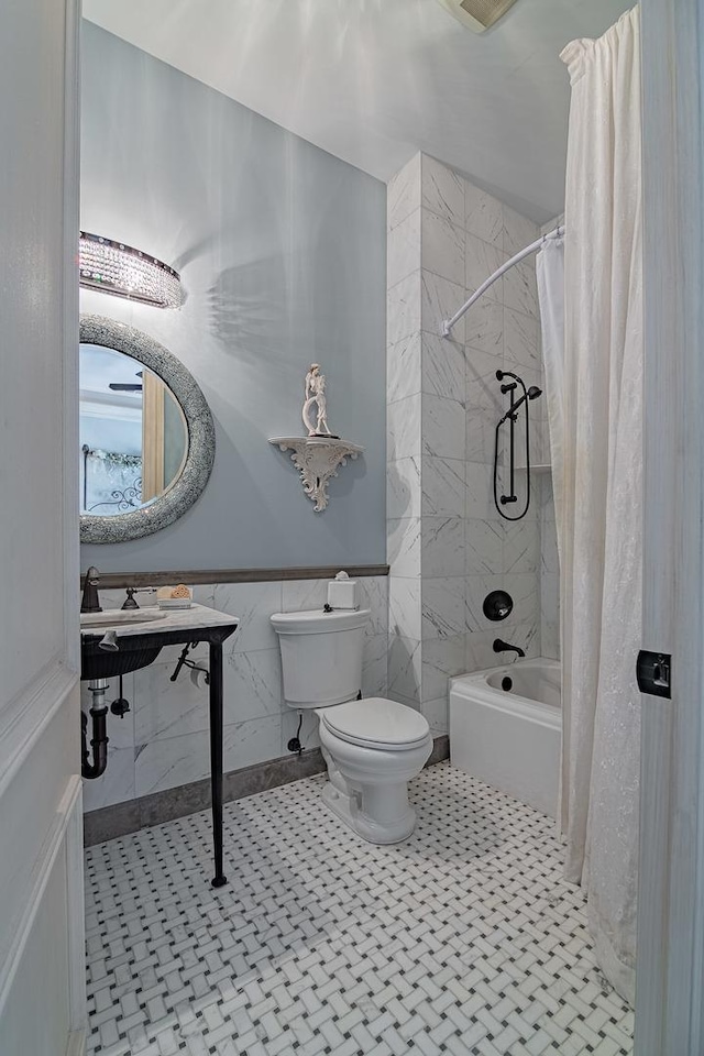 113 Carmela Ct, Bloomingdale, IL 60108 - bathroom featuring shower / tub combo, a wainscoted wall, tile walls, and tile patterned floors