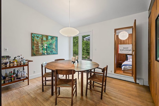 2110 Heather Rd, Geneva, IL 60134 - dining room with light wood-style flooring, a baseboard heating unit, lofted ceiling, and baseboards