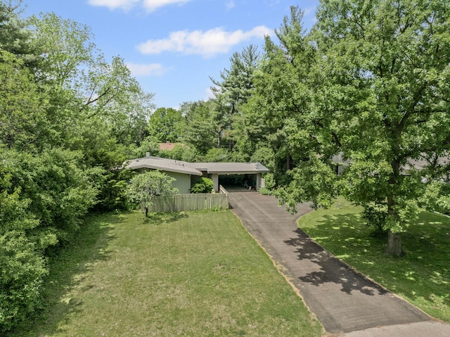 2110 Heather Rd, Geneva, IL 60134 - view of front of property with asphalt driveway, an attached carport, and a forest view