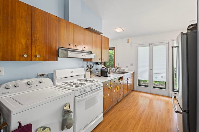 2110 Heather Rd, Geneva, IL 60134 - kitchen with washer / dryer, white range with gas stovetop, freestanding refrigerator, under cabinet range hood, and brown cabinets
