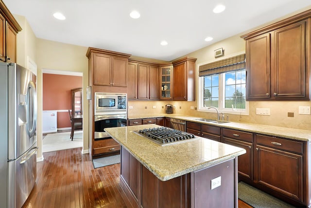 35 Open Pkwy N, Hawthorn Woods, IL 60047 - kitchen featuring appliances with stainless steel finishes, a sink, dark wood-type flooring, backsplash, and light stone counters