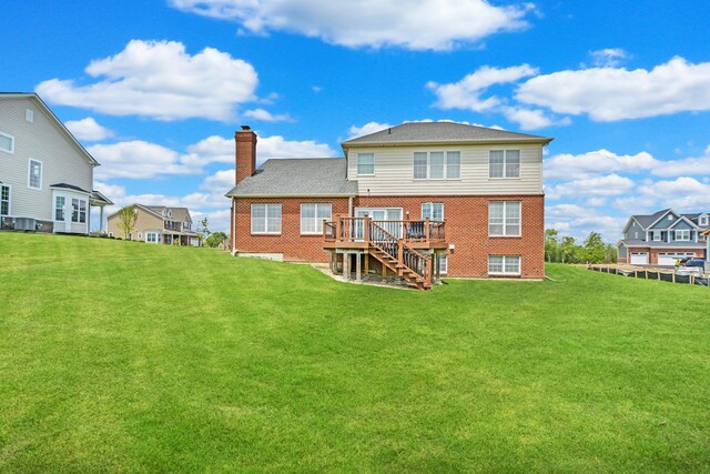 35 Open Pkwy N, Hawthorn Woods, IL 60047 - back of house with stairway, a chimney, a wooden deck, brick siding, and a lawn
