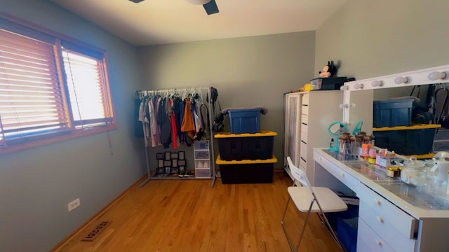 interior space with visible vents, ceiling fan, and wood finished floors