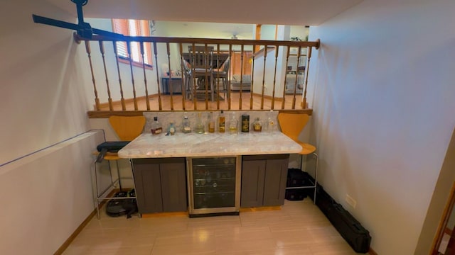 bar featuring a dry bar, light tile patterned floors, and wine cooler