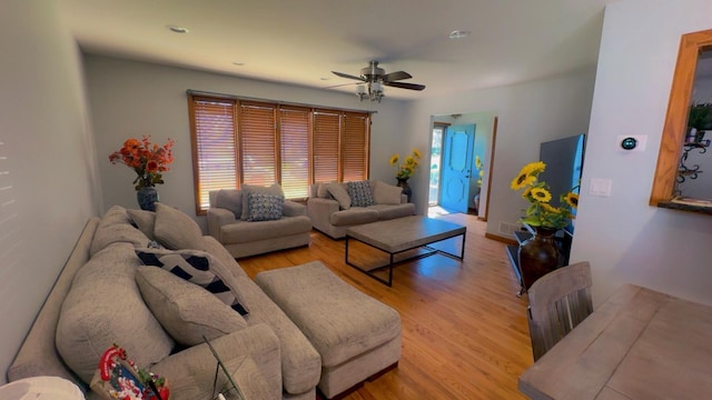 living area featuring a ceiling fan and light wood-style floors