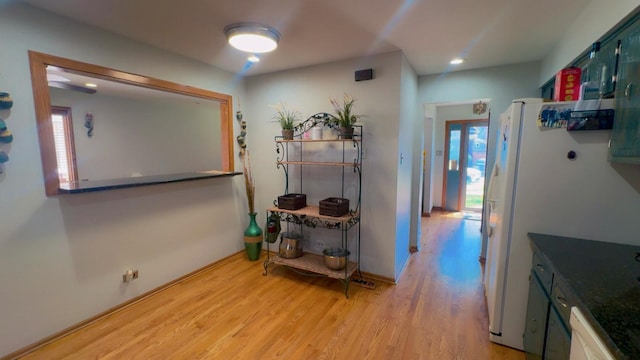 hallway featuring light wood-style flooring and plenty of natural light