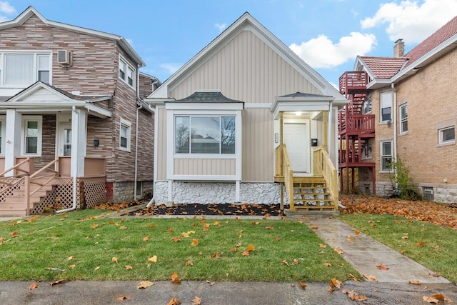 view of front of home with board and batten siding and a front yard