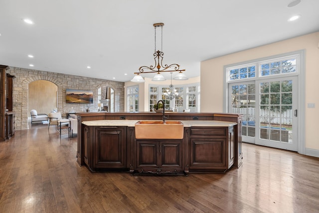 26W051 W Mohican Dr, Wheaton, IL 60189 - kitchen with a sink, dark brown cabinets, a chandelier, and dark wood-style flooring