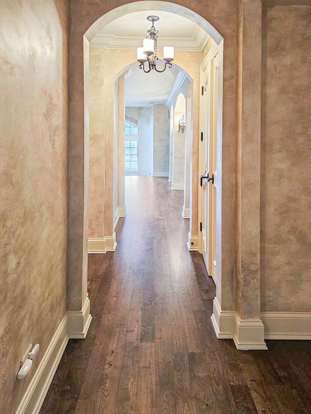 26W051 W Mohican Dr, Wheaton, IL 60189 - corridor featuring dark wood-type flooring, a chandelier, ornamental molding, and arched walkways