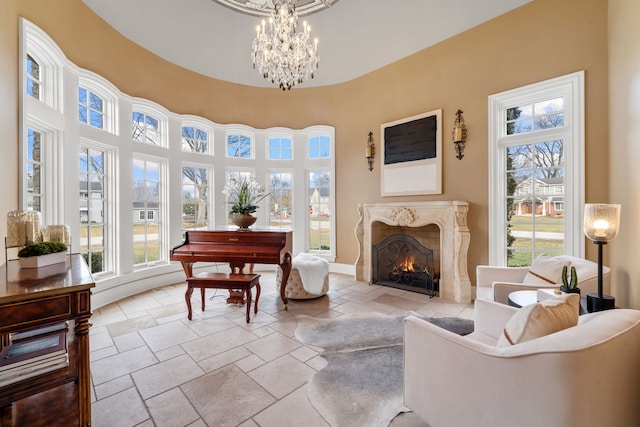 26W051 W Mohican Dr, Wheaton, IL 60189 - sitting room with a chandelier, a high end fireplace, stone tile flooring, and a high ceiling