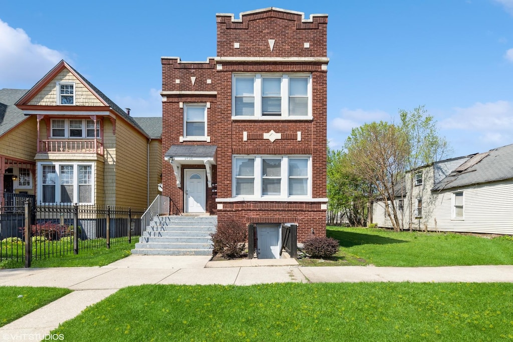 1436 E 71st Pl, Chicago, IL 60619 - view of front facade with brick siding, fence, and a front lawn