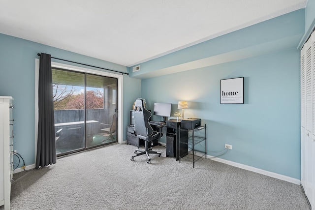 carpeted office space featuring baseboards and visible vents