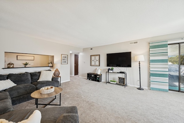carpeted living area featuring baseboards and visible vents