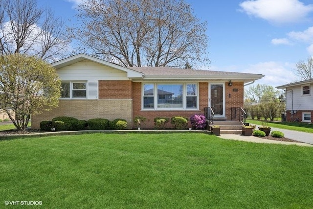 single story home with a front yard and brick siding