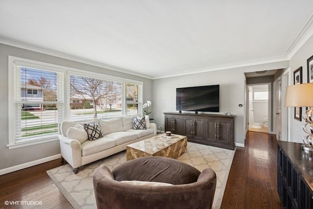 living area featuring a healthy amount of sunlight, ornamental molding, and wood finished floors