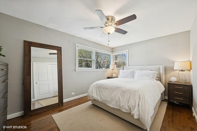 bedroom with baseboards, ceiling fan, and wood finished floors