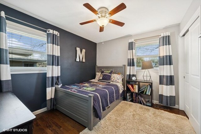bedroom with baseboards, ceiling fan, wood finished floors, and a closet