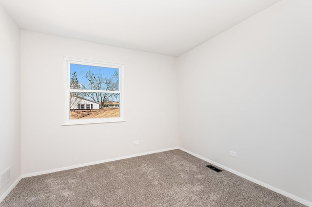 unfurnished room featuring visible vents, carpet, and baseboards