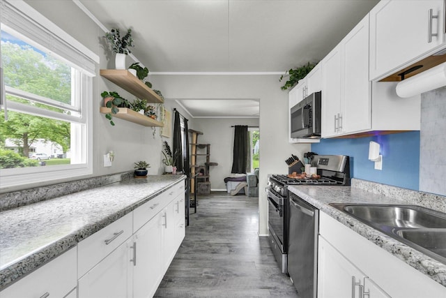 1304 Briarcliff Dr, Urbana, IL 61801 - kitchen featuring stainless steel appliances, white cabinetry, open shelves, light countertops, and wood finished floors