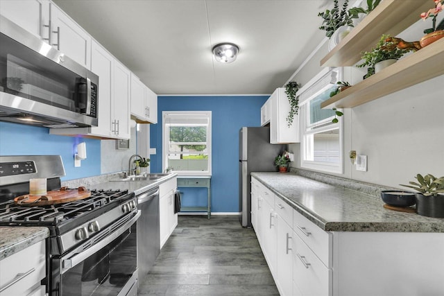 1304 Briarcliff Dr, Urbana, IL 61801 - kitchen with appliances with stainless steel finishes, open shelves, a sink, dark wood finished floors, and white cabinetry