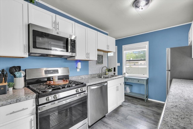 1304 Briarcliff Dr, Urbana, IL 61801 - kitchen with stainless steel appliances, a sink, light wood-style flooring, white cabinetry, and light countertops