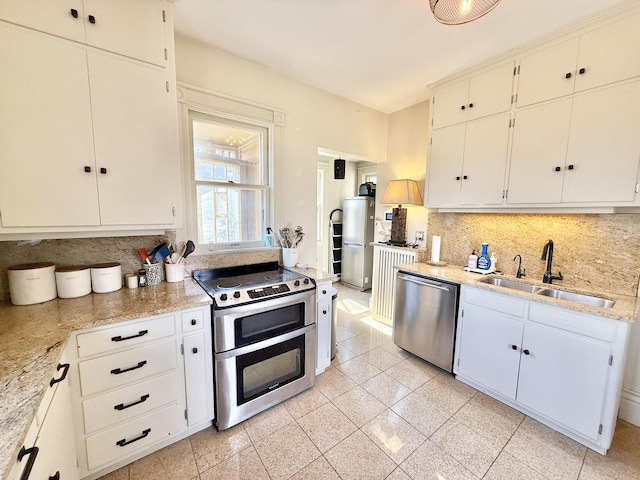 kitchen featuring light stone countertops, a sink, stainless steel appliances, granite finish floor, and tasteful backsplash