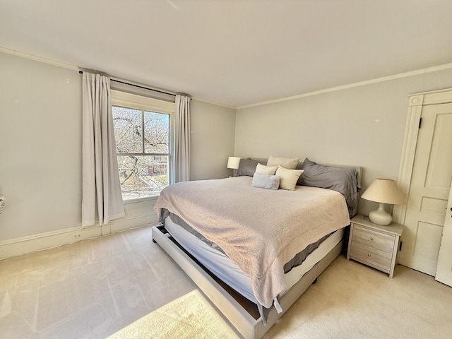 bedroom with crown molding and light colored carpet