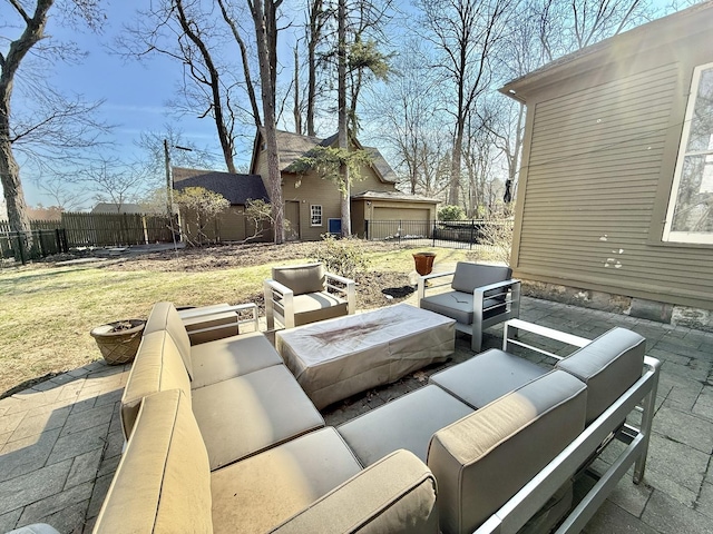 view of patio with an outdoor living space with a fire pit and a fenced backyard