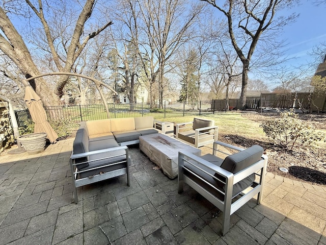 view of patio / terrace with an outdoor living space with a fire pit and a fenced backyard