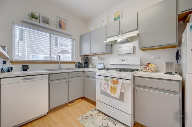 1126 Village Center Pkwy Unit 6, Aurora, IL 60506 - kitchen with a sink, white appliances, under cabinet range hood, light countertops, and light wood-style floors