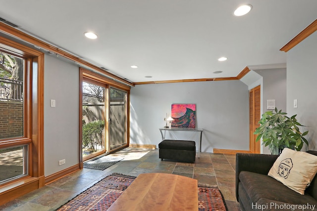 living area featuring stone tile flooring, ornamental molding, baseboards, and recessed lighting