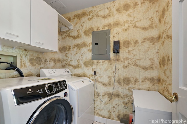 laundry room featuring cabinet space, washing machine and dryer, and electric panel
